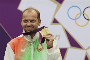 Sergei Martynov of Belarus holds his gold medal won in the Men's 50m rifle prone shooting event at the London 2012 Olympic Games